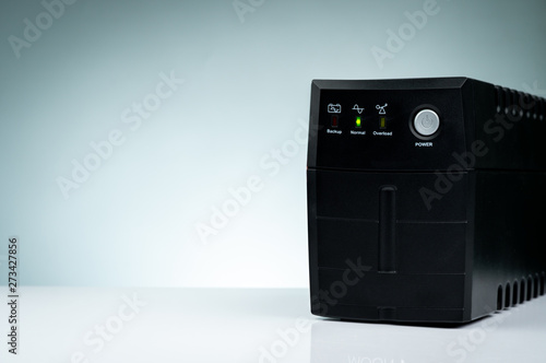 Uninterruptible power supply. Backup Power UPS with battery isolated on table. UPS for PC. Equipment for computer system at office for security. Power protection solutions from home to data center.