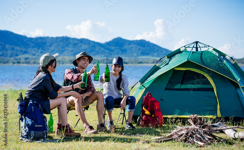 Camping camp in nature happy friends party and drinking beer together in summer