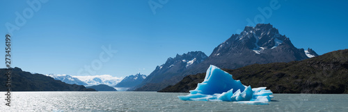 Panorama of the Grey with the blue iceberg (bergy bit floating in it. Torres del Paine National Park, Chile