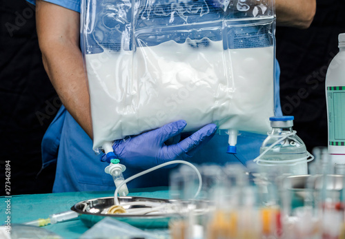 Nurse preparing medication for parenteral nutrition in a hospital, conceptual image