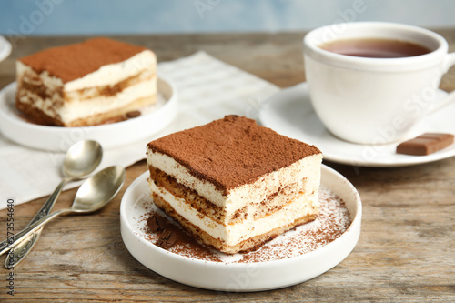 Composition with tiramisu cakes and tea on table