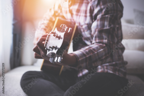 singer playing guitar on bed, concept of recreation.