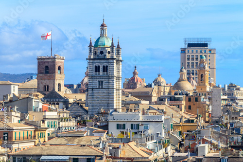 GENOA, ITALY - MARCH 9, 2019: The historic medieval center of Genoa - San Lorenzo Cathedral and a flag of Genoa