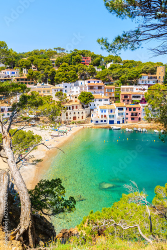 View of colorful houses in sea bay with beach in Sa Tuna coastal village, Costa Brava, Spain