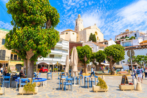 CADAQUES VILLAGE, SPAIN - JUN 4, 2019: Church square with restaurants in Cadaques port, Costa Brava, Spain.