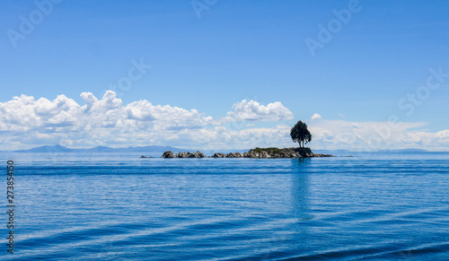 Small island with cloudy sky on lake titicaca in Bolivia