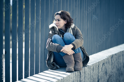 Young attractive woman crying suffering from depression sitting