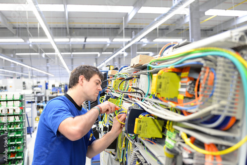 Montage im Maschinenbau durch jungen Arbeiter in einer modernen Fabrik // Assembly in mechanical engineering by young workers in a modern factory