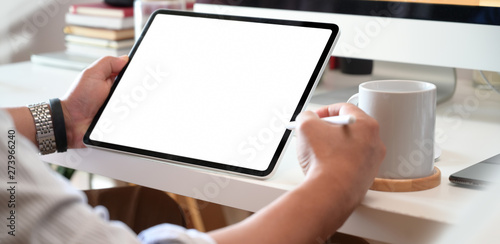 Designer or businessman working with tablet pc on desk