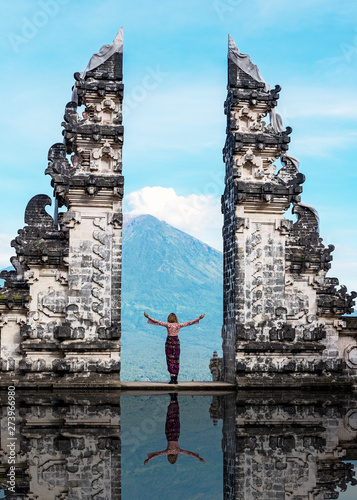 Unidentified person at the gate of Pura Penataran Lempuyang infront of Mt Agung Volcano in Bali Indonesia.