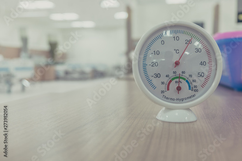 Thermo hygrometer on office table with blur background