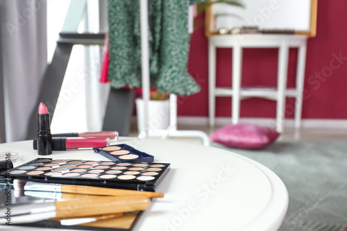 Table with cosmetics in modern makeup room