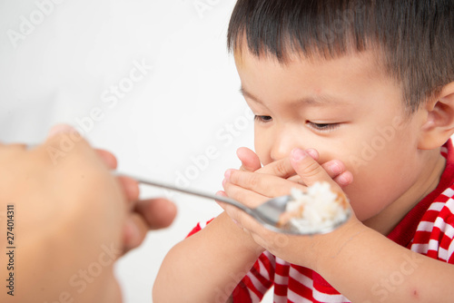 Little toddler Asian boy with hand close his mouth no eat his food