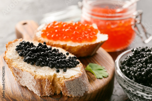 Sandwiches with delicious caviar on board, closeup