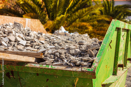 Metal container with construction waste rubble