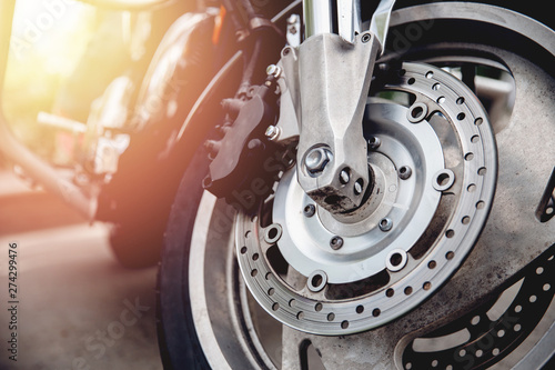 Closeup detail of steering wheel of motorcycle, perforated brake disc