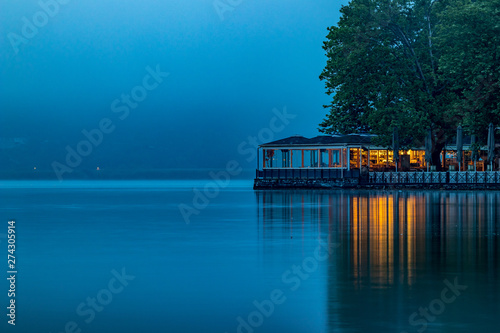 Ioannina, Greece, lake misty early spring morning with fog over the lake Pamvotida calm waters. Light reflections, high contrast mystical picture, long exposure photograph