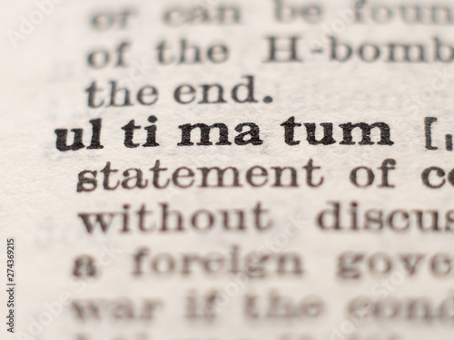 Dictionary definition of word ultimatum, selective focus.