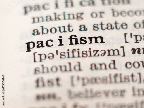 Dictionary definition of word pacifism, selective focus.