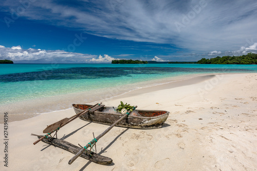 Port Orly sandy beach with palm trees, Espiritu Santo Island, Vanuatu.