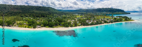 Port Orly sandy beach with palm trees, Espiritu Santo Island, Vanuatu.