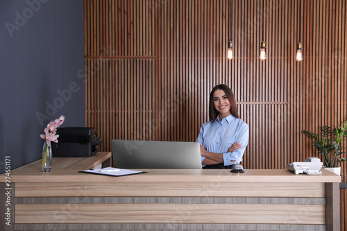 Portrait of receptionist at desk in lobby