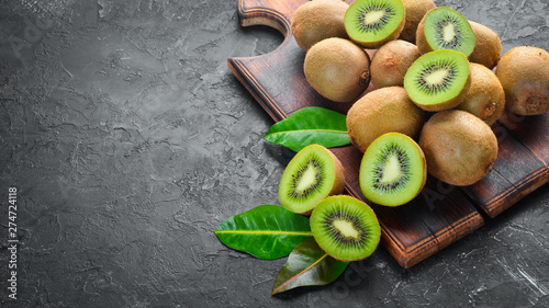 Fresh Kiwi on a black background. Top view. Free space for your text.