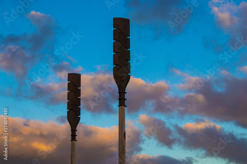 Petone New Zealand wooden waka oars from maori culture standing looking up into sunset sky