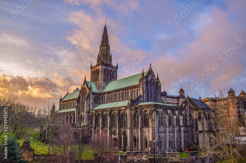 Beautiful Glasgow St Mungo’s Cathedral illuminated clouds in sunset 