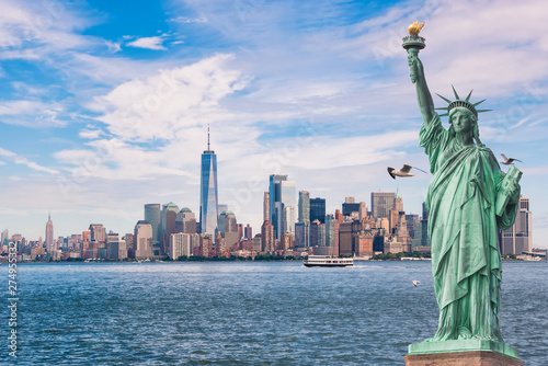 Statue of Liberty in front of the Manhattan skyline, in new york city,USA, with seagulls and boats