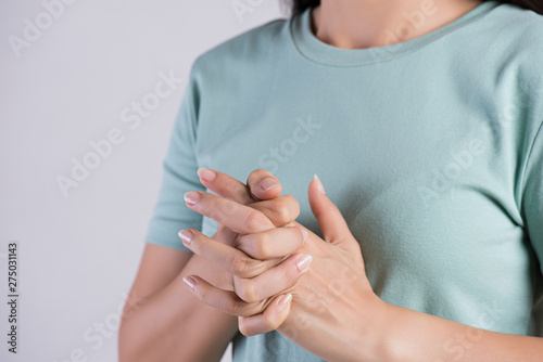 Healthcare and medical concept. Close up woman cracking knuckles.