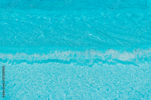 clear blue water waves background closeup at sea coast line