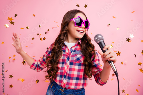 Close up photo of cool attractive crazy lady kid have fun visit event future musician loud voice solo hold hand free time stylish checked shirt isolated over pink background long haircut hairdo