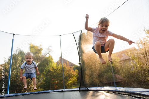 Kids jumping high on trampoline