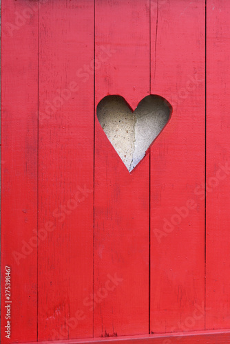 close on a heart-shaped on a red wooden shutter