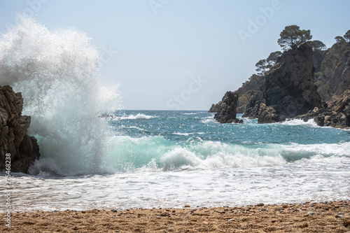 waves splashing against the rocks in a cove