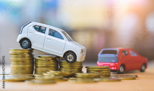 Car and stack of coin. Saving money for car concept. Car finance, buy car new concept.