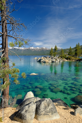 Vertical image of the gorgeous and clear boulder strewn shoreline of Lake Tahoe