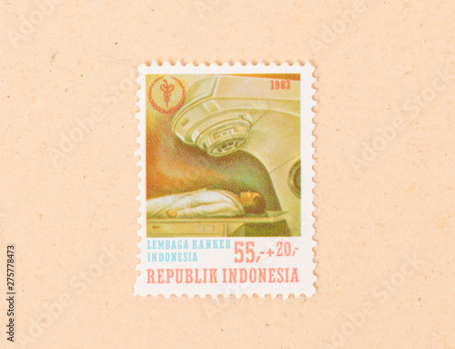 INDONESIA - CIRCA 1983: A stamp printed in Indonesia shows cancer research in Indonesia, circa 1983