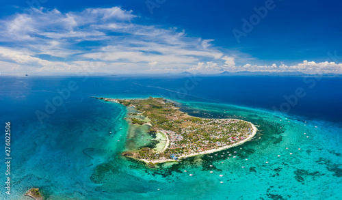 Aerial drone view of a small tropical island and surrounding coral reef (Malapascua)