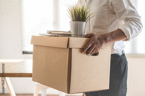 Downsize business. Employee moving off from office after sacked from company.