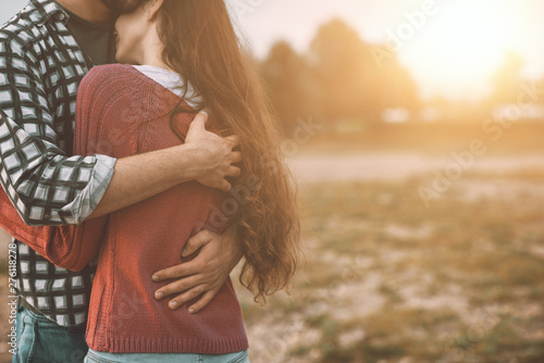 Young loving couple hugging outdoors