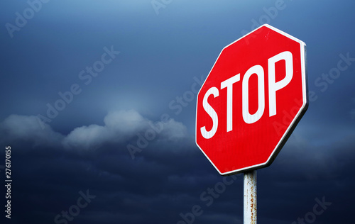 Conceptual stop sign with stormy background. Warning, caution and danger sign
