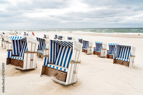 Beach - chairs on the island Sylt. Germany. Summer cloudy weather.