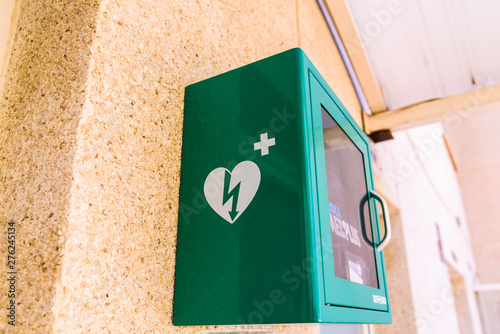 Valencia, Spain - June 24, 2019: Public defibrillator to save lives of people suffering heart attacks, placed in public spaces to use in case of emergency.