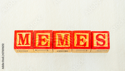 The term memes visually displayed on a clear background using colorful wooden toy blocks image in landscape format