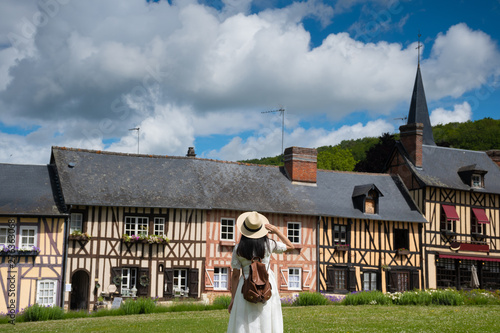 Woman is traveling at destination in Northern vintage old town village in Normandie district in France. 