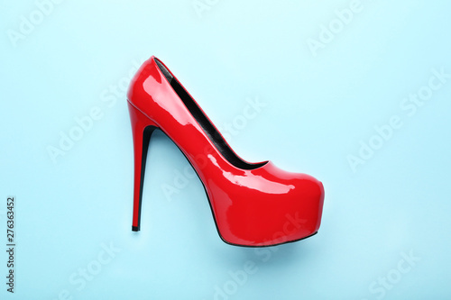 Red high heel shoes on blue background