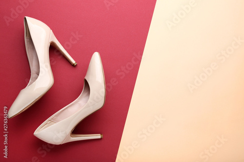 Beige high heel shoes on colorful background