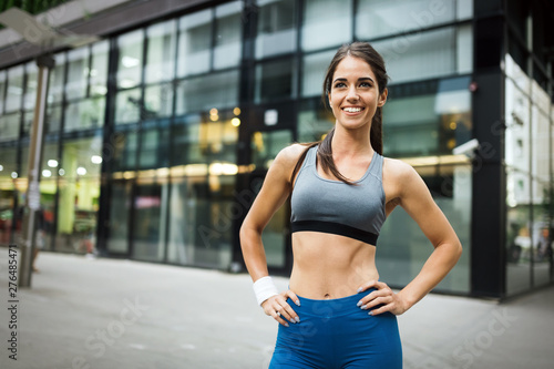 Picture of young attractive happy fitness woman outdoor